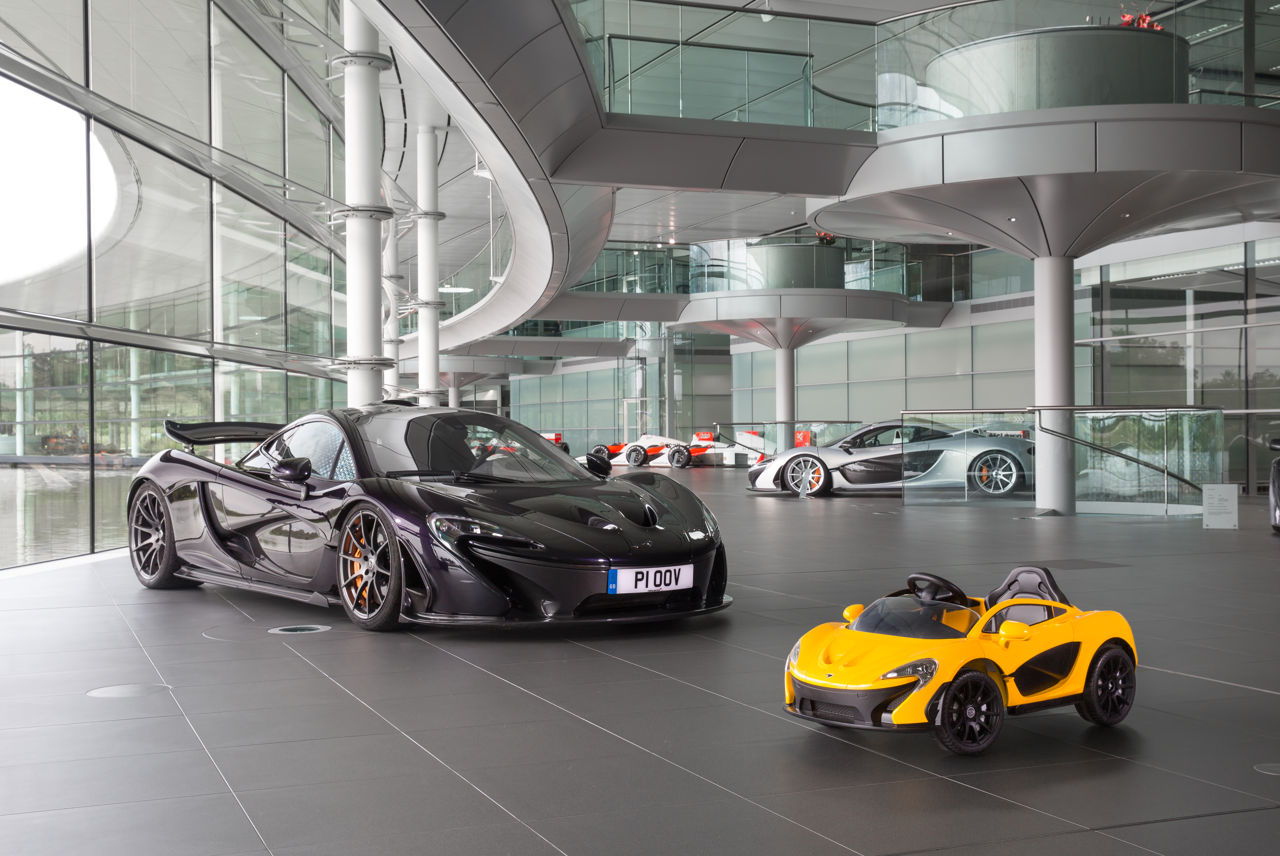Luxury sports cars displayed in a modern showroom with a sleek design.