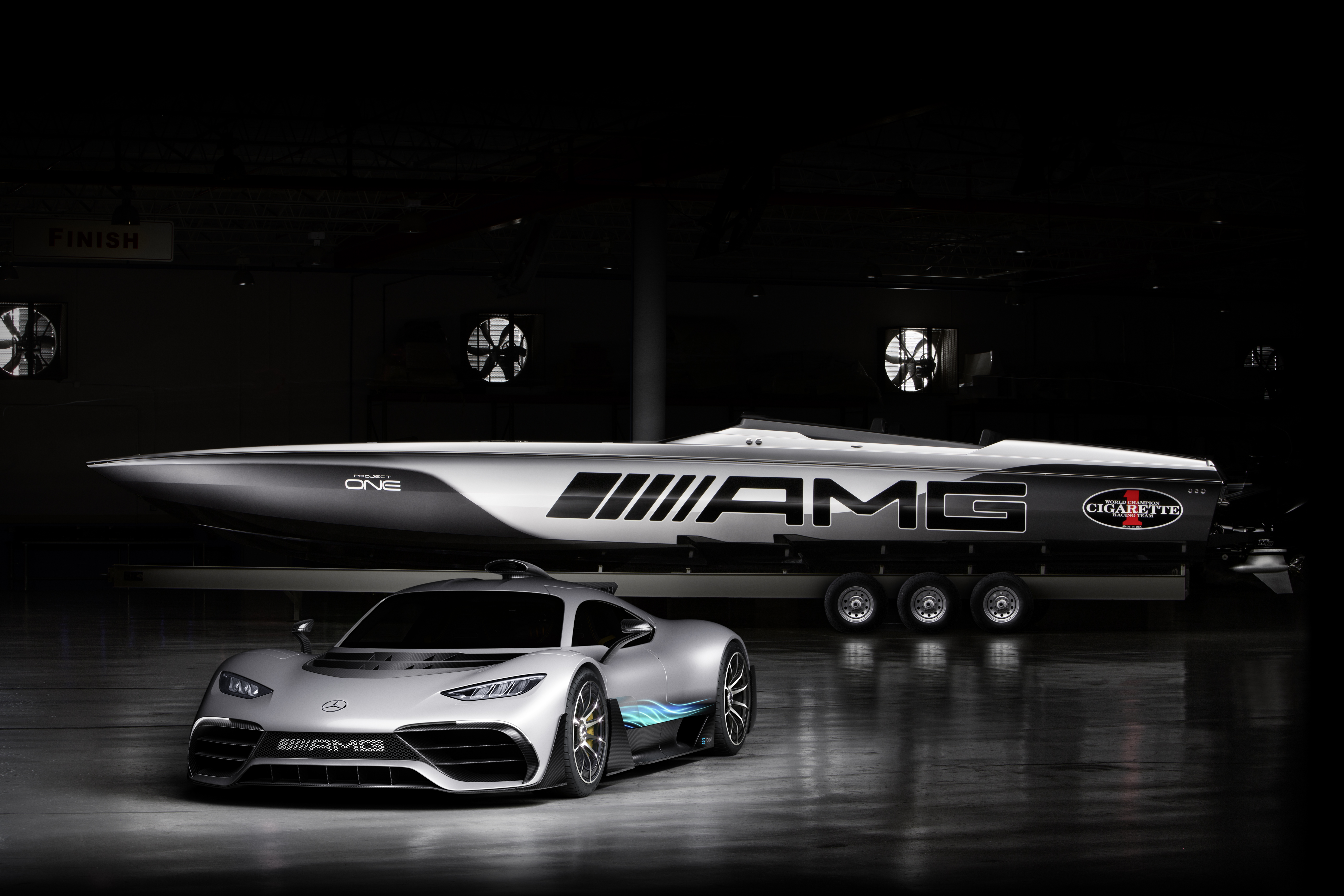 A luxury Mercedes AMG GT car parked near a private jet in a dark hangar.