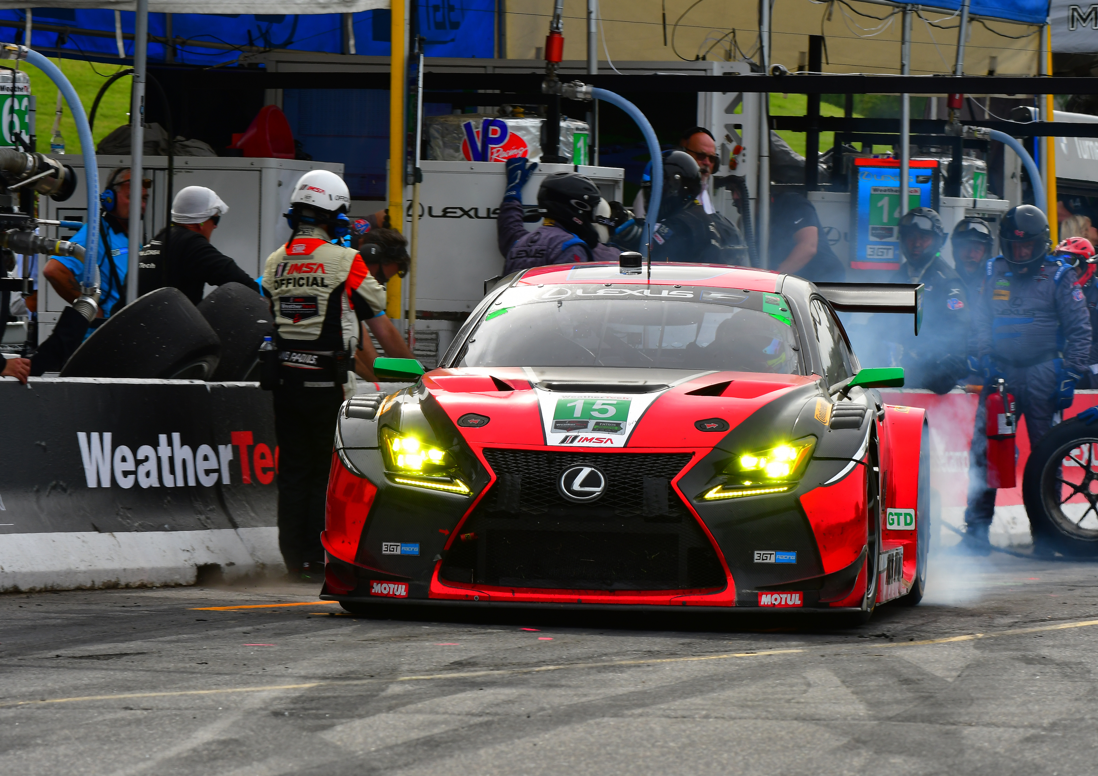 Lexus racing car in pit stop during a motorsport event.