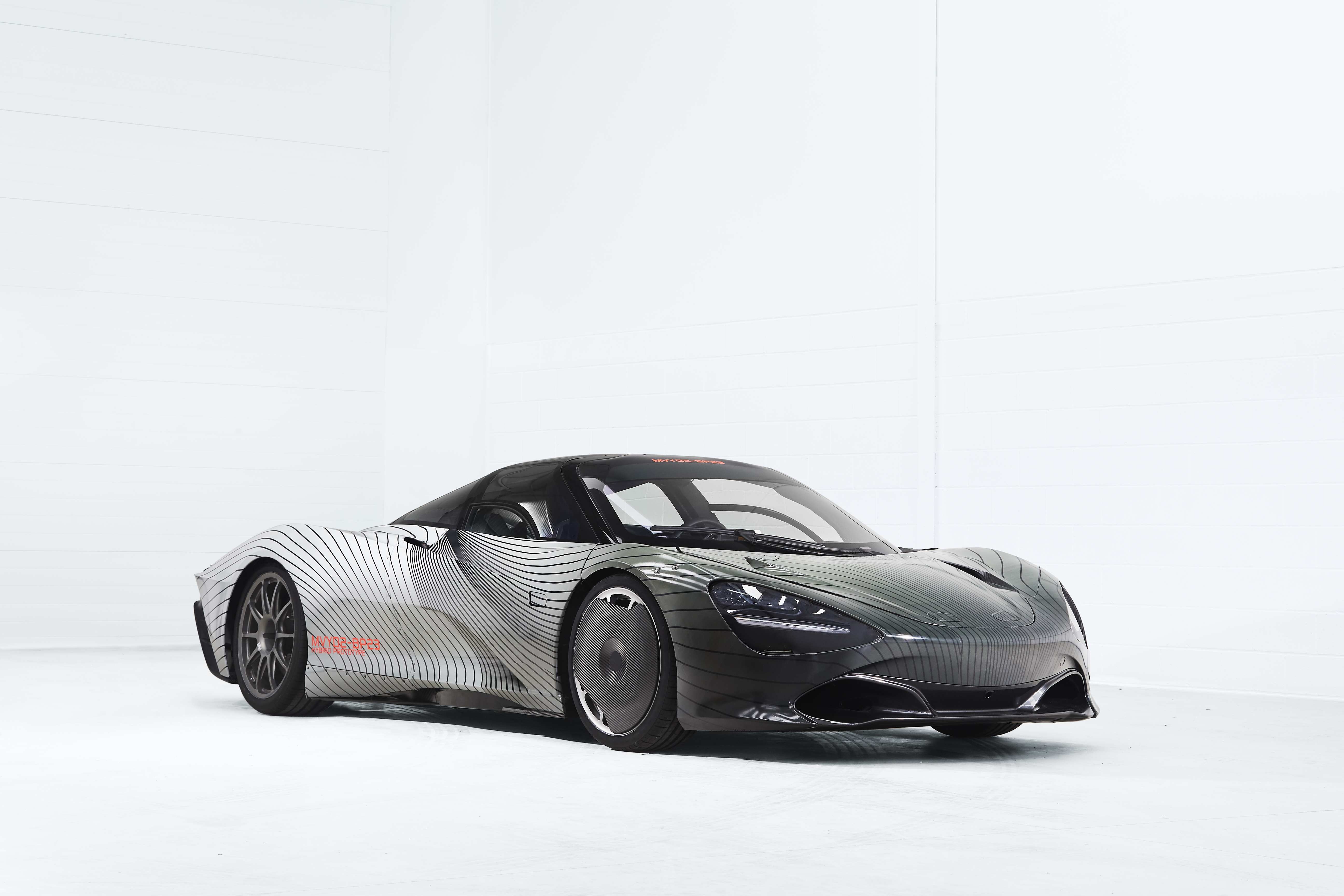 A sleek silver sports car with black wheels on display.