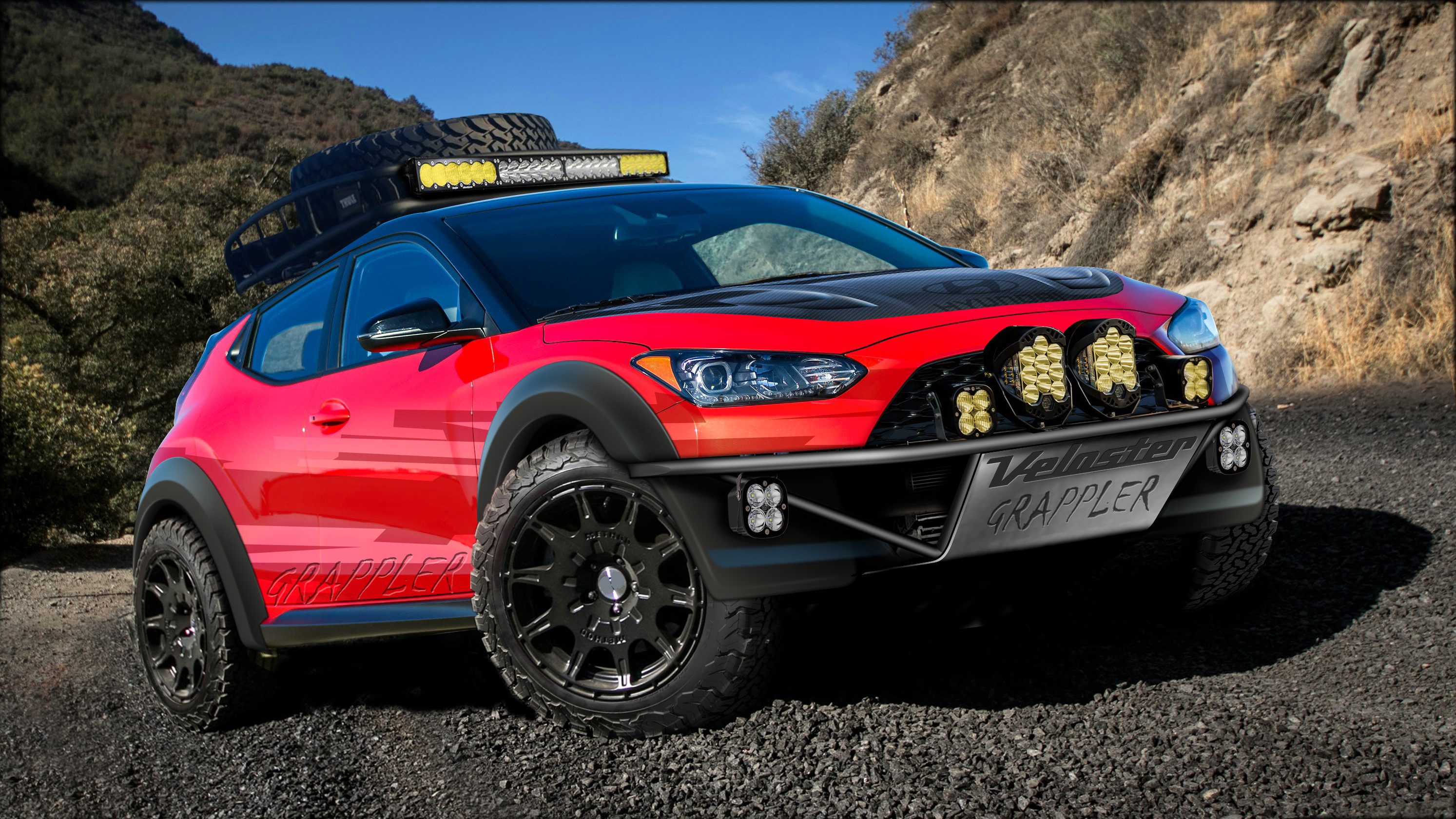 Red off-road vehicle parked on a rocky terrain.