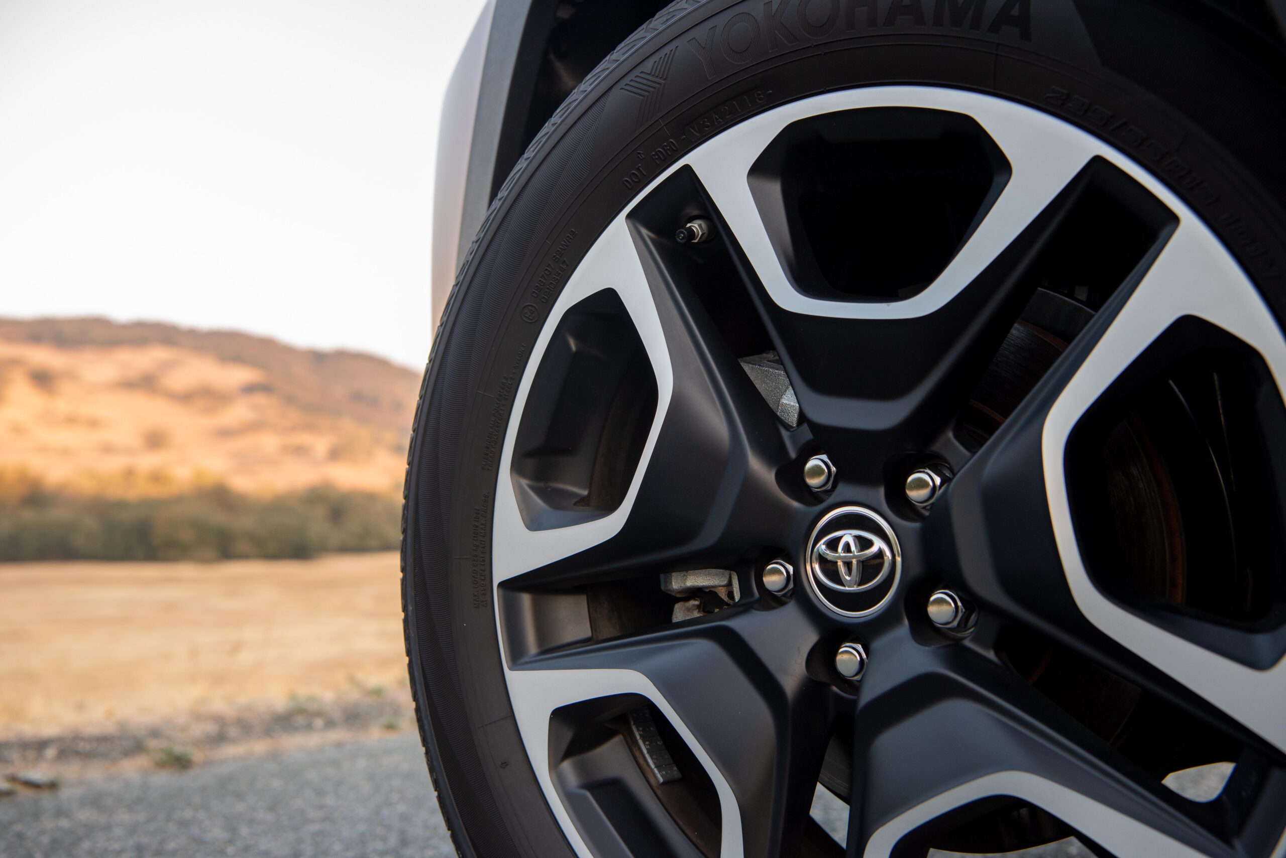 Close-up of a Toyota vehicle's black and silver alloy wheel.