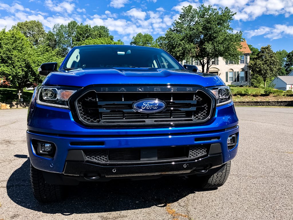 Blue Ford truck parked on a sunny day with a clear sky.