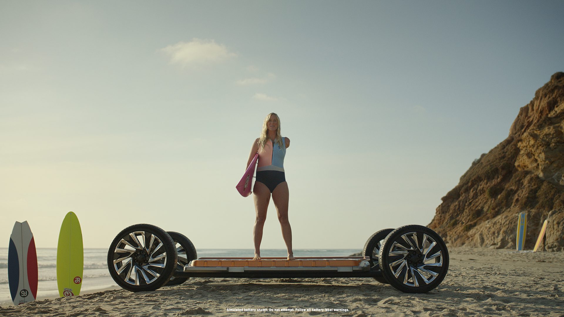 Woman standing confidently on a hoverboard platform with a clear sky background.