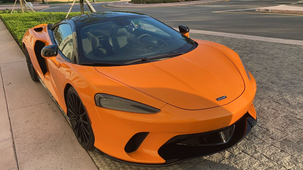 Bright orange sports car parked on the street.
