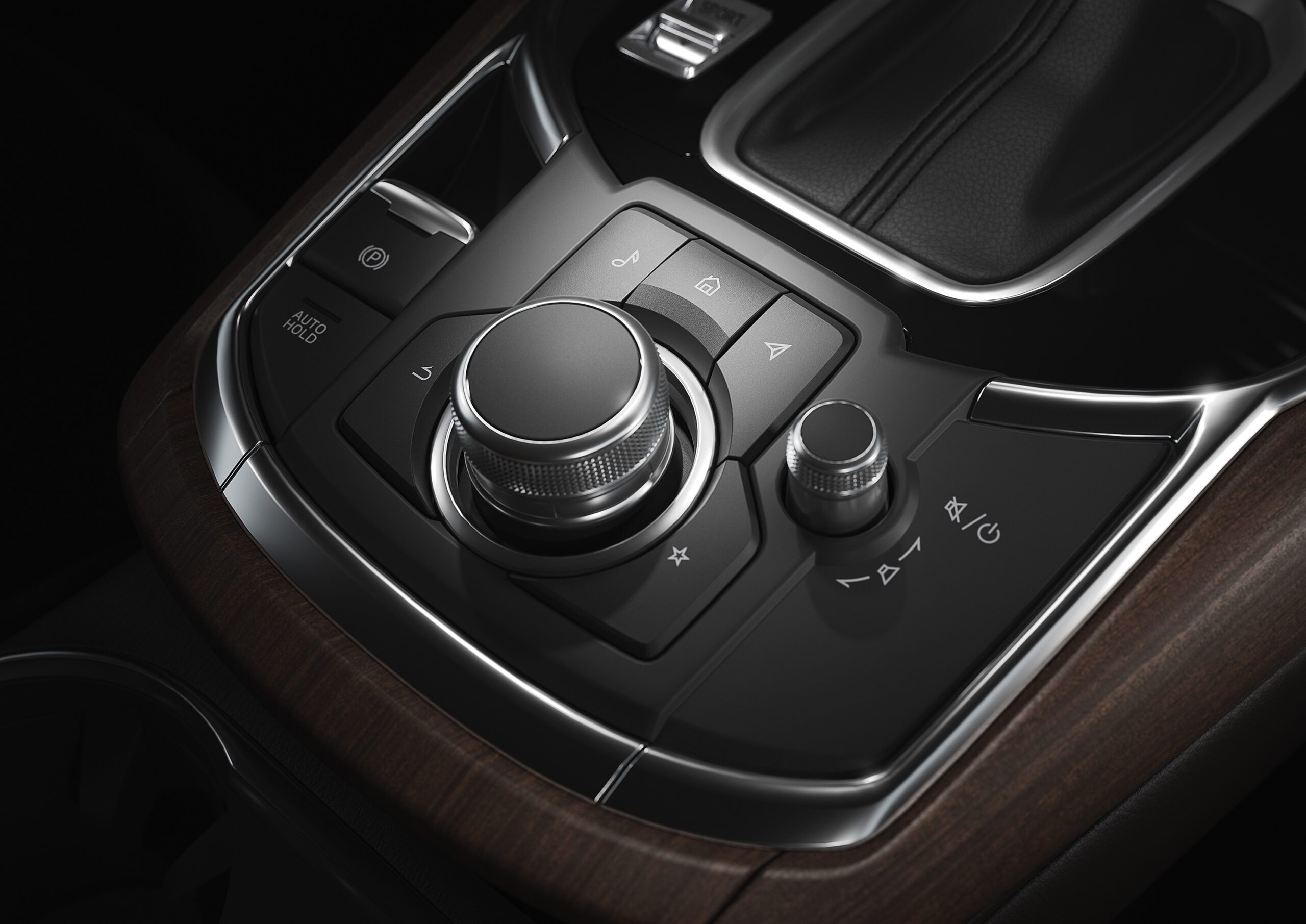 Close-up of a car's central control dial and buttons.