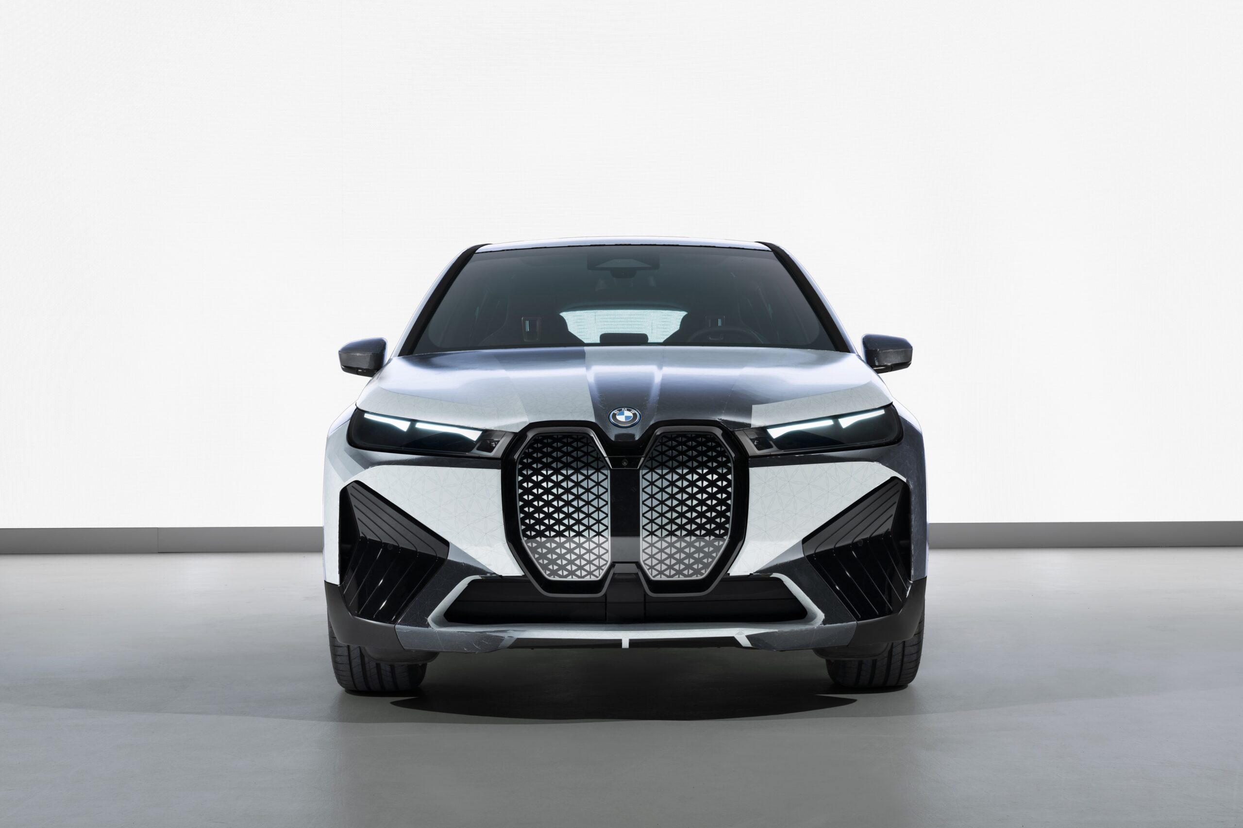 Front view of a sleek black BMW car with a prominent kidney grille.