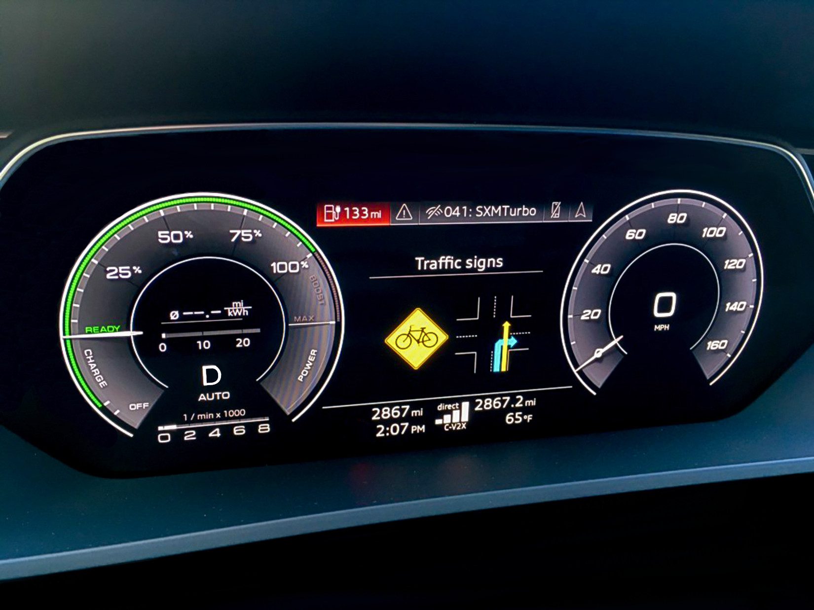 Car dashboard displaying speed, navigation, and safety alerts.