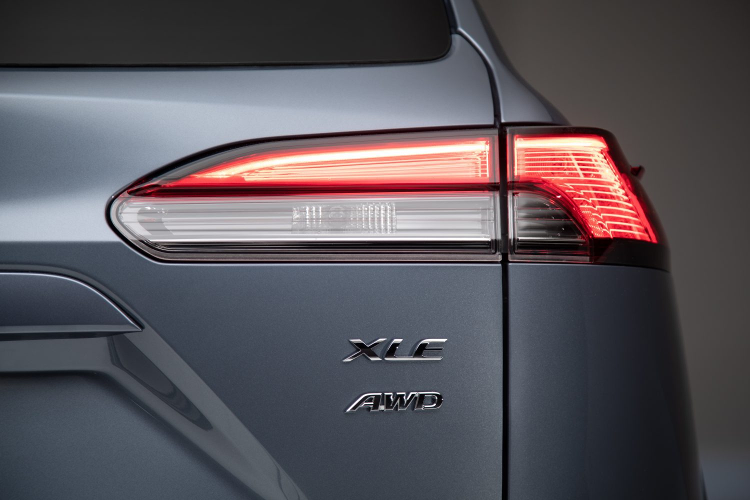 Close-up of a car's rear emblem showing XLE AWD badge.