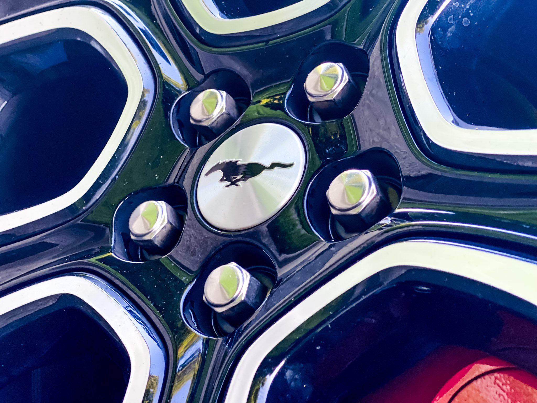 Close-up of a car wheel hub with a stylish emblem.