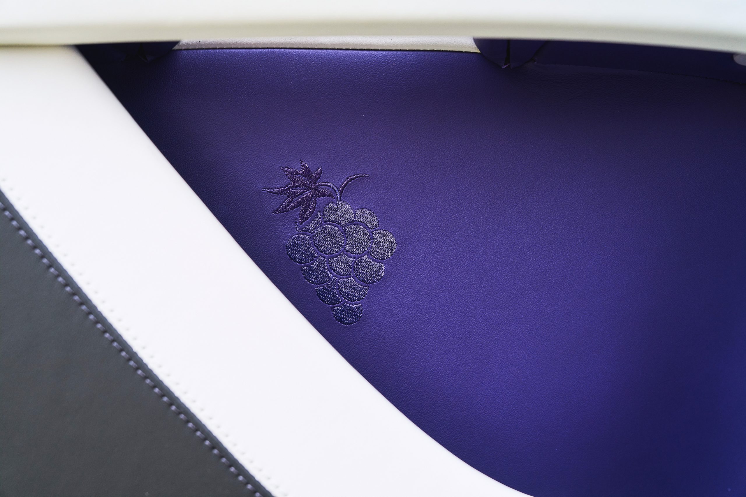 Close-up of a purple surface with embossed grapes design.