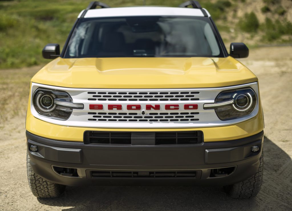Front view of the Bronco Sport Heritage Edition featuring the distinctive Oxford White heritage grille with Race Red "BRONCO" lettering.