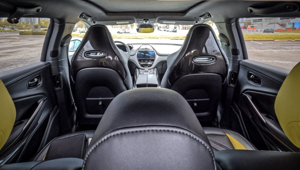 Interior shot of Aston Martin DBX707 with plush leather seats: "Luxurious interior of the Aston Martin DBX707 featuring sumptuous leather seats, exemplifying bespoke craftsmanship."