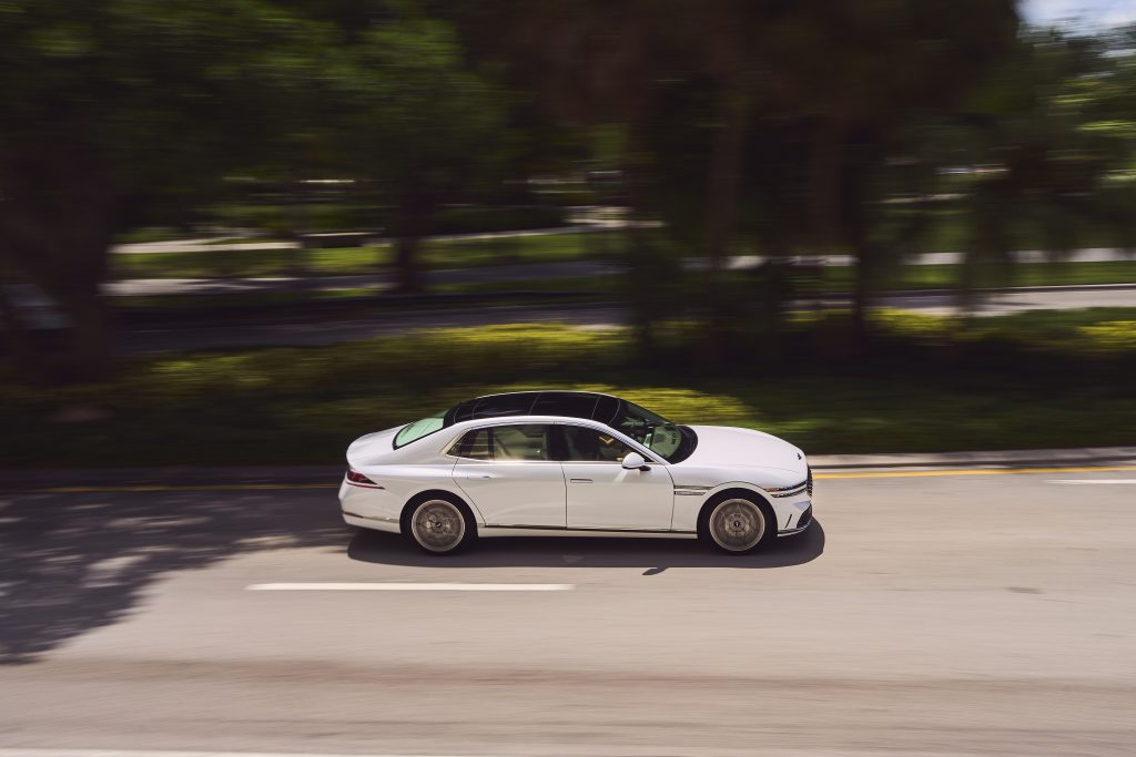 Front view of the 2023 Genesis G90, showcasing its bold grille, sleek lines, and LED headlights, embodying modern luxury