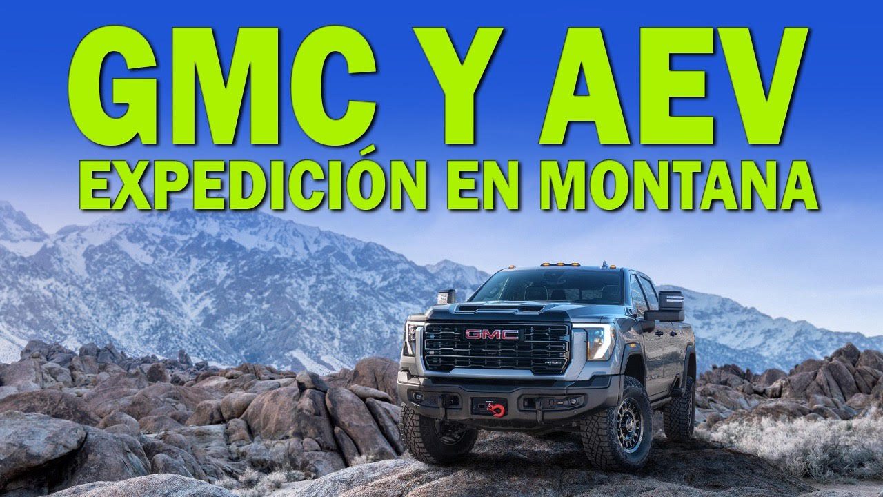 GMC Y AE expedition truck in a rugged mountain landscape.
