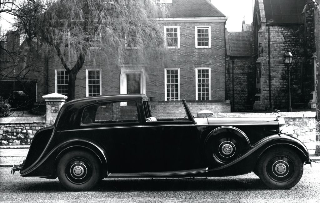 Rolls-Royce Phantom III, surrounded by period-appropriate elements from the 1930s. Visit Carsfera.com