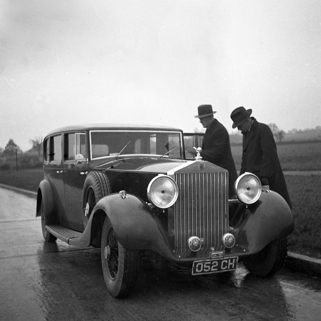 Rolls-Royce Phantom III, surrounded by period-appropriate elements from the 1930s. Visit Carsfera.com