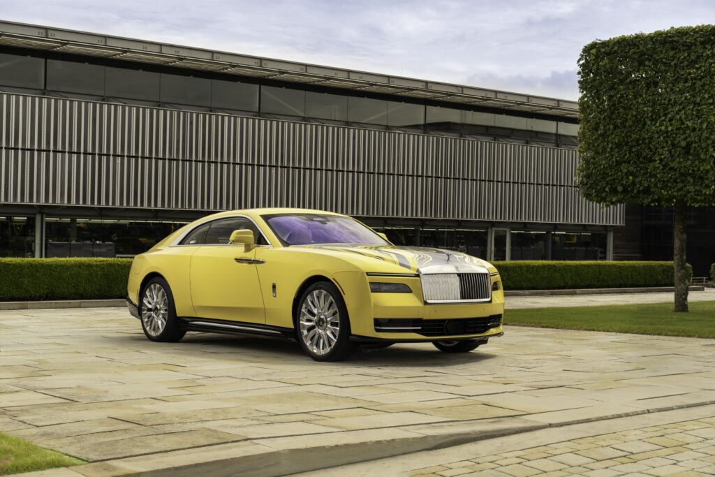 Rolls-Royce Spectre Semaphore in vibrant Semaphore Yellow with unique Marbled Paint Spill artwork on the bonnet, showcasing luxury craftsmanship at Monterey Car Week 2024