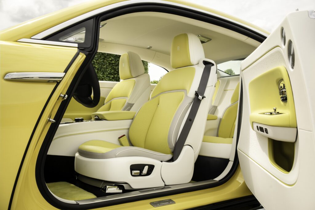 Rolls-Royce Spectre Semaphore in vibrant Semaphore Yellow with unique Marbled Paint Spill artwork on the bonnet, showcasing luxury craftsmanship at Monterey Car Week 2024