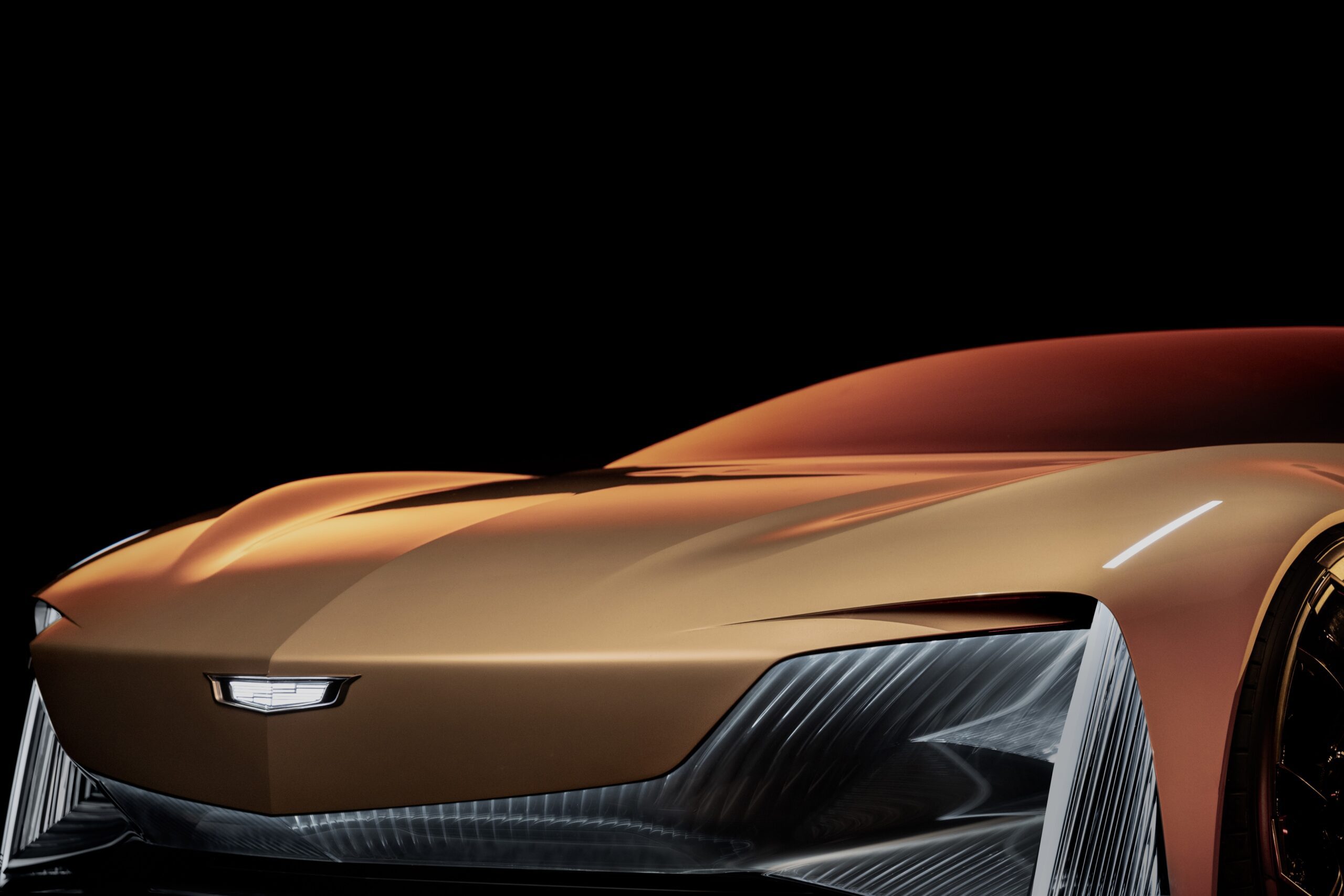 Sleek, futuristic bronze sports car with aerodynamic design and sharp headlights.