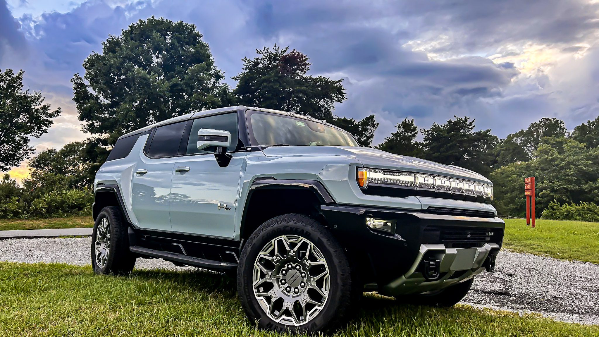 A rugged light blue SUV parked outdoors under a cloudy sky.