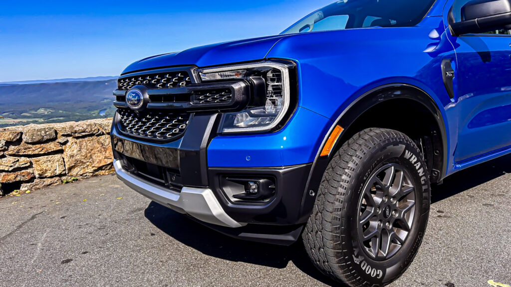 A dynamic image showcasing the **2024 Ford Ranger XLT SuperCrew 4x4** in **Velocity Blue Metallic**, featuring its rugged design, **off-road capability**, and **EcoBoost engine**. The truck is equipped with the **FX4 package**, offering **superior performance** on various terrains. Highlighted elements include **SYNC4 technology**, **towing capacity**, and the vehicle's **mid-size truck versatility**. Perfect for those seeking adventure, durability, and advanced **tech features** in a pickup.