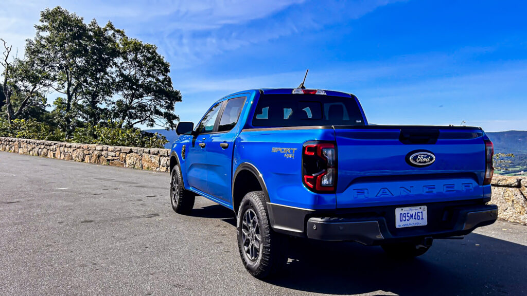 A dynamic image showcasing the **2024 Ford Ranger XLT SuperCrew 4x4** in **Velocity Blue Metallic**, featuring its rugged design, **off-road capability**, and **EcoBoost engine**. The truck is equipped with the **FX4 package**, offering **superior performance** on various terrains. Highlighted elements include **SYNC4 technology**, **towing capacity**, and the vehicle's **mid-size truck versatility**. Perfect for those seeking adventure, durability, and advanced **tech features** in a pickup.