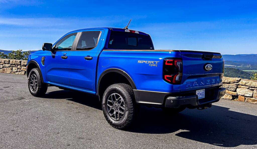 A dynamic image showcasing the **2024 Ford Ranger XLT SuperCrew 4x4** in **Velocity Blue Metallic**, featuring its rugged design, **off-road capability**, and **EcoBoost engine**. The truck is equipped with the **FX4 package**, offering **superior performance** on various terrains. Highlighted elements include **SYNC4 technology**, **towing capacity**, and the vehicle's **mid-size truck versatility**. Perfect for those seeking adventure, durability, and advanced **tech features** in a pickup.