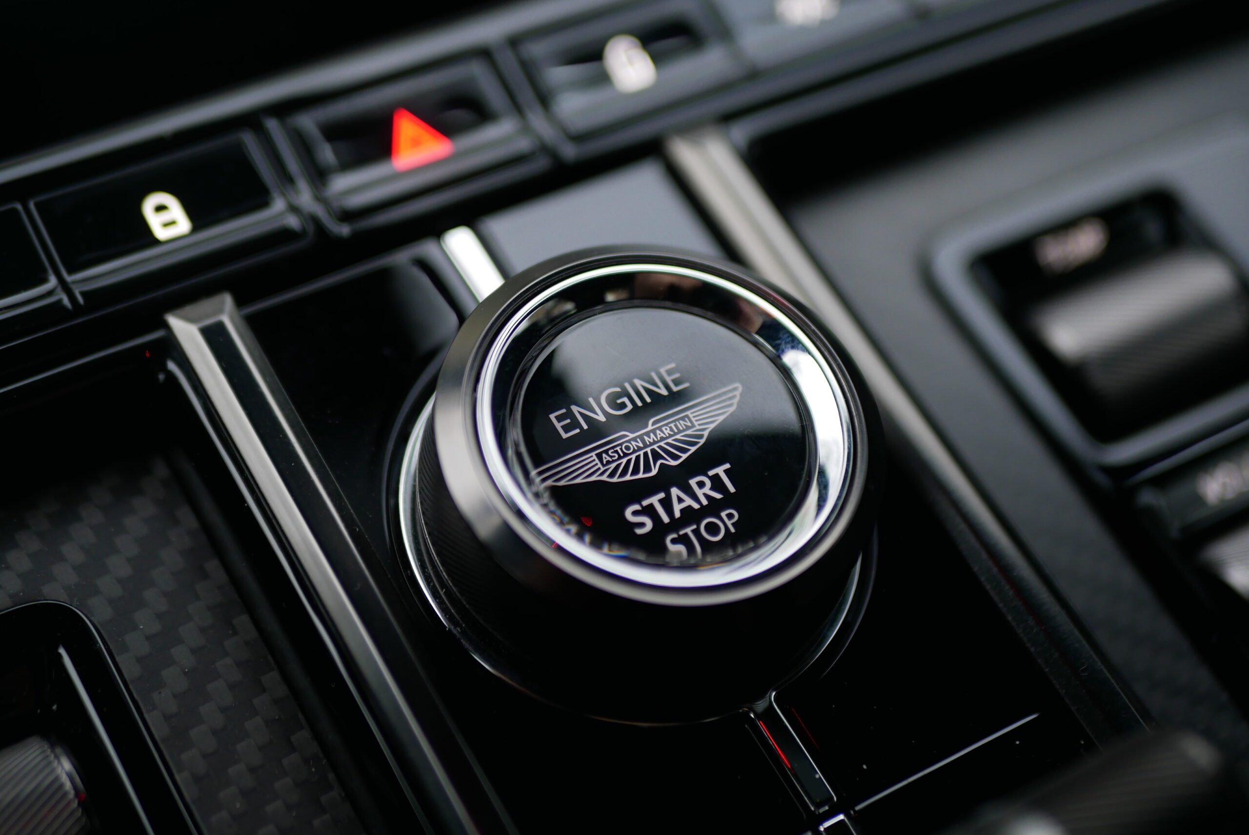 Close-up of a car's engine start/stop button.