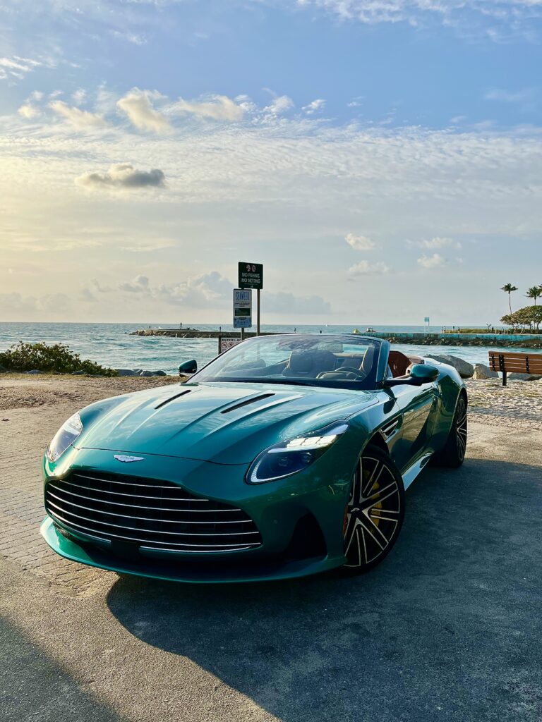 Aston Martin DB12 Volante luxury convertible photographed in Miami's Wynwood district, surrounded by vibrant street art and murals