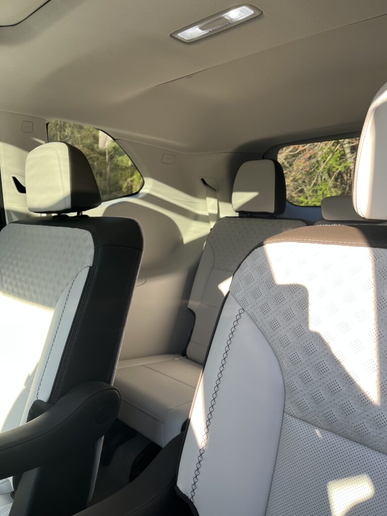 2025 GMC Acadia Denali driving on the road during a test drive showing road presence and handling