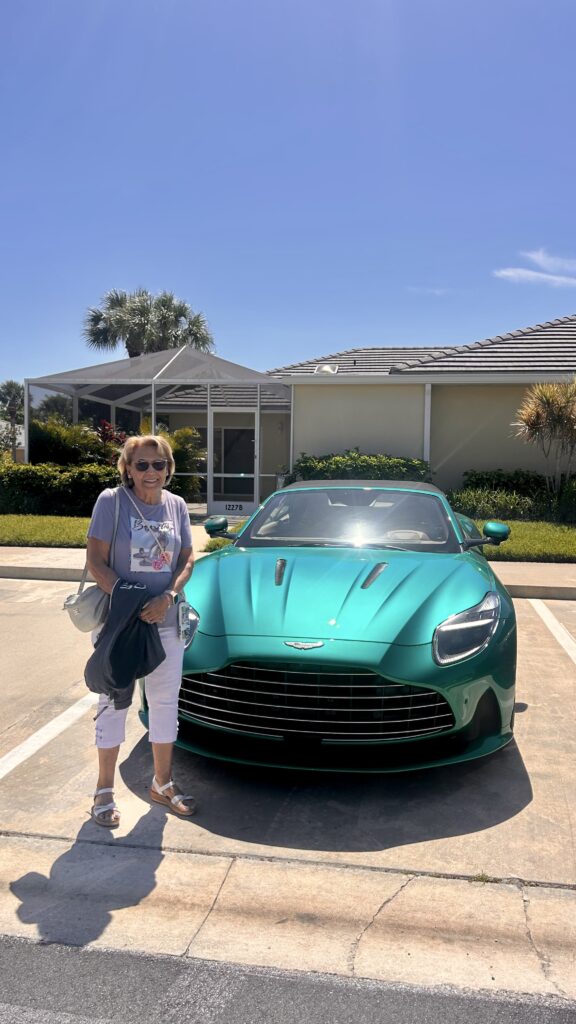 Aston Martin DB12 Volante luxury convertible photographed in Miami's Wynwood district, surrounded by vibrant street art and murals