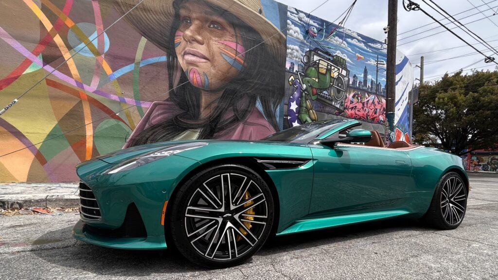 Aston Martin DB12 Volante luxury convertible photographed in Miami's Wynwood district, surrounded by vibrant street art and murals