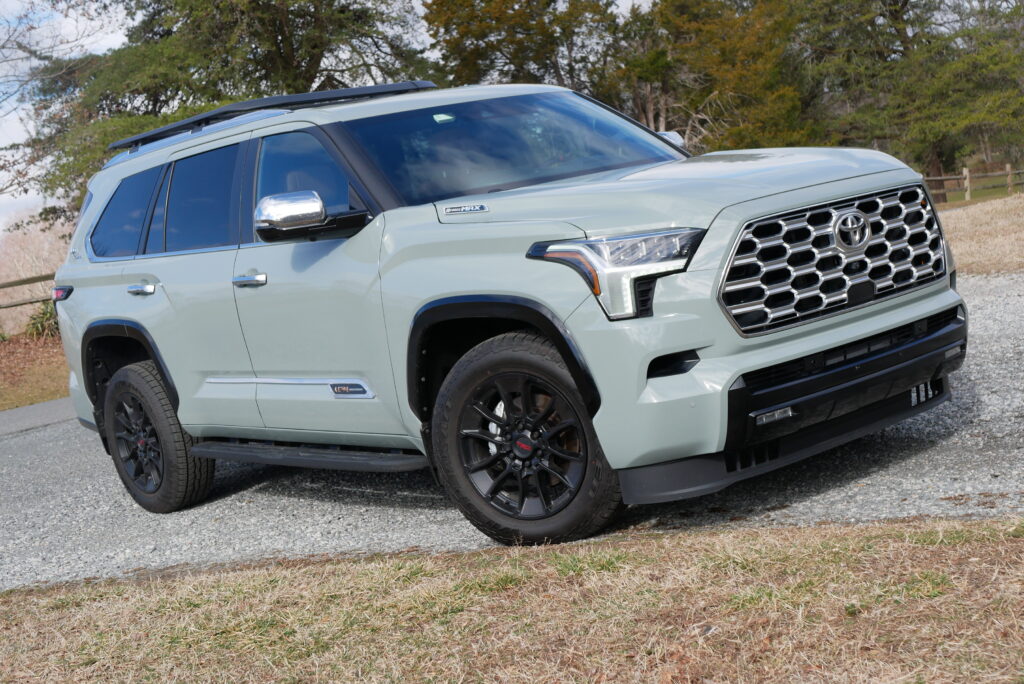 Side profile of the Sequoia Hybrid SUV parked off-road, highlighting its elevated stance and off-road tires.