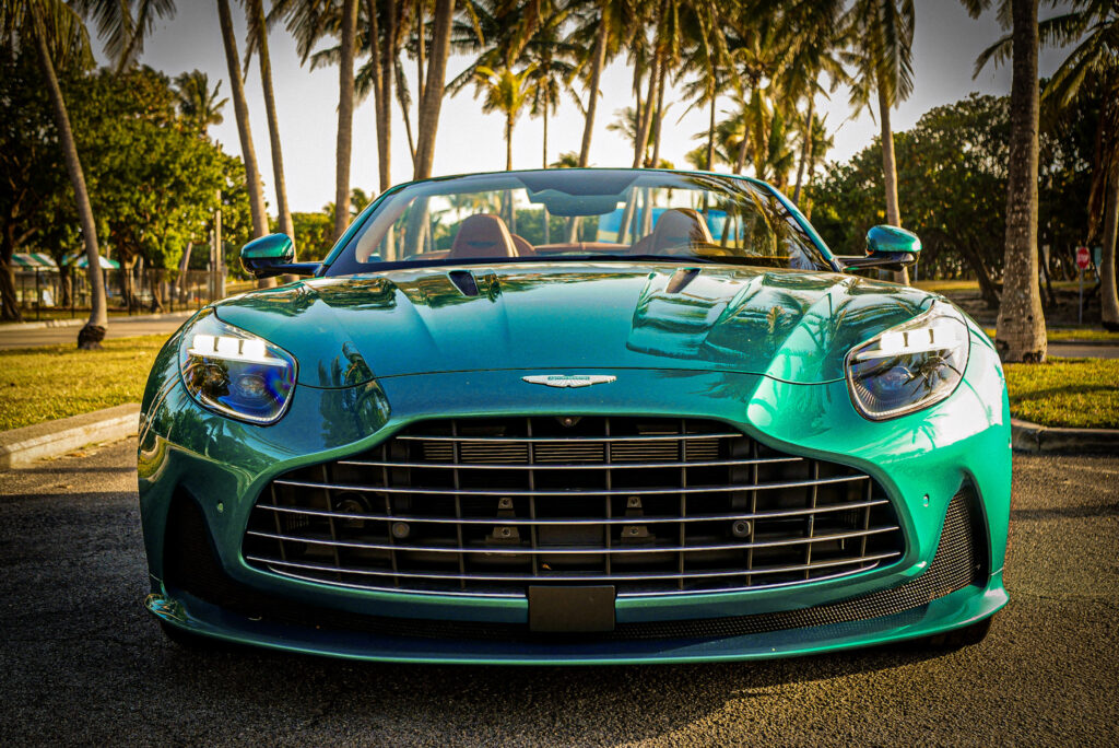 Aston Martin DB12 Volante luxury convertible photographed in Miami's Wynwood district, surrounded by vibrant street art and murals