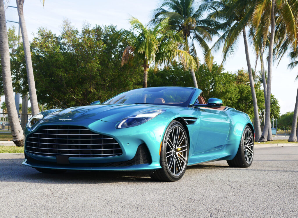 Aston Martin DB12 Volante luxury convertible photographed in Miami's Wynwood district, surrounded by vibrant street art and murals