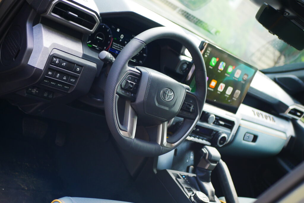 2025 Toyota Tacoma Trailhunter – factory-built overland truck with hybrid engine, ARB suspension, and off-road gear on rugged terrain