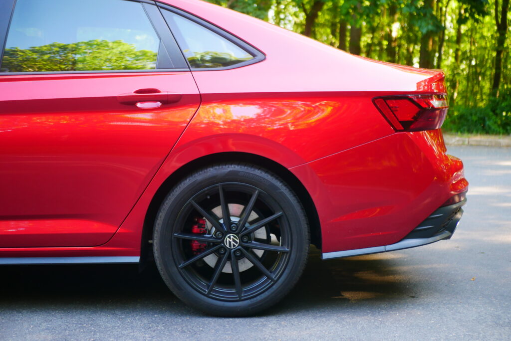 2025 Volkswagen Jetta GLI Autobahn sedan with sporty design, turbocharged engine, and premium features shown driving on city streets