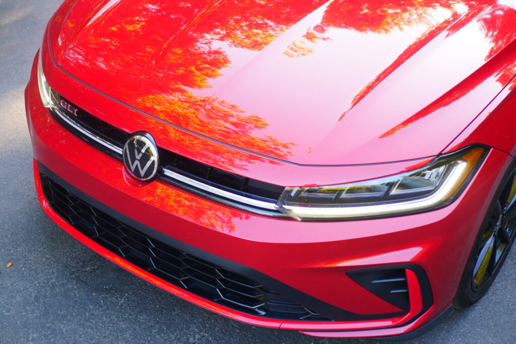 2025 Volkswagen Jetta GLI Autobahn sedan with sporty design, turbocharged engine, and premium features shown driving on city streets