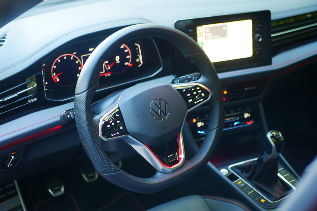 2025 Volkswagen Jetta GLI Autobahn sedan with sporty design, turbocharged engine, and premium features shown driving on city streets