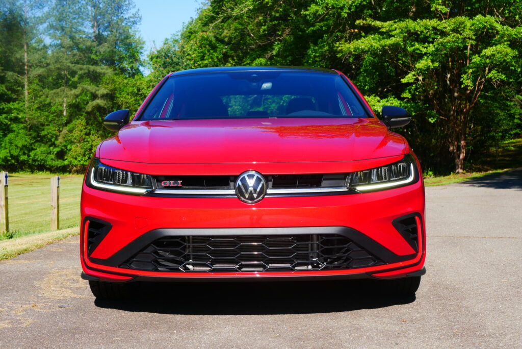 2025 Volkswagen Jetta GLI Autobahn sedan with sporty design, turbocharged engine, and premium features shown driving on city streets