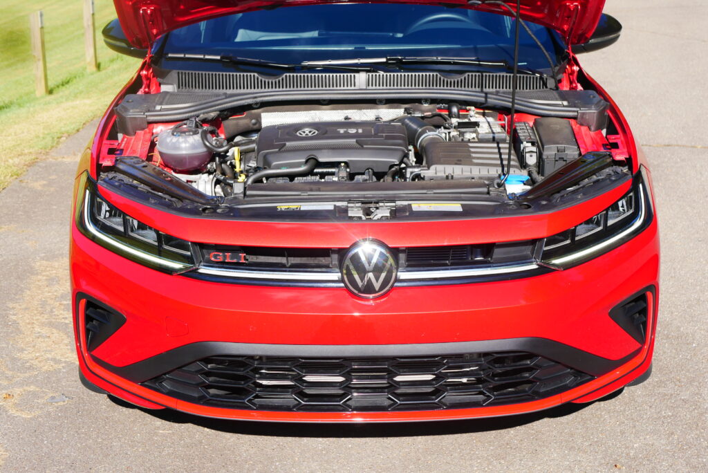 2025 Volkswagen Jetta GLI Autobahn sedan with sporty design, turbocharged engine, and premium features shown driving on city streets