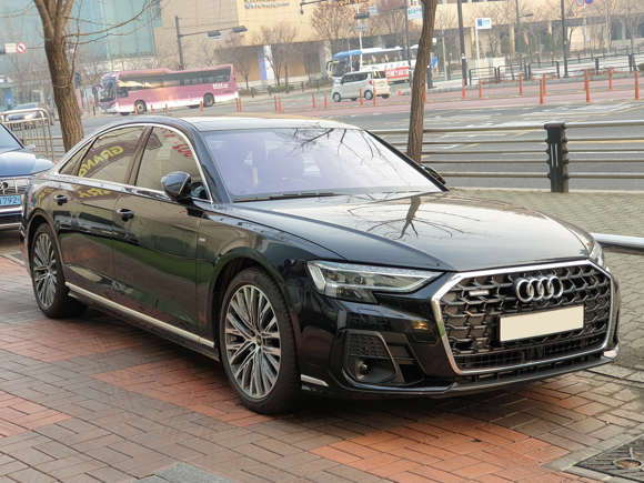A sleek black Audi sedan parked on a city street.