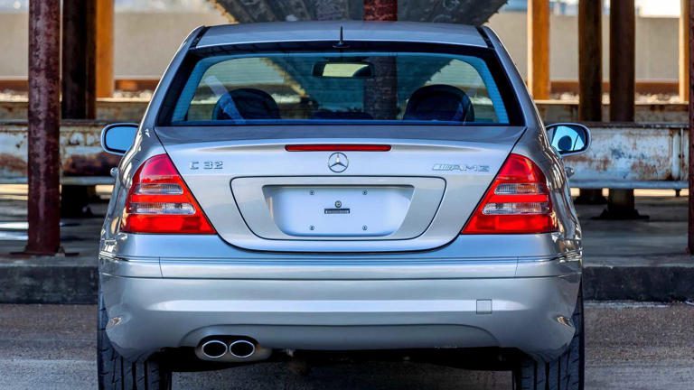 Rear view of a silver luxury sedan with dual exhausts and a clean license plate area.