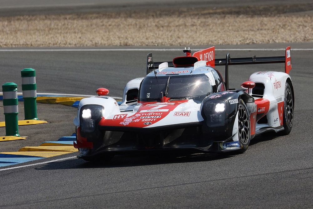 Toyota hybrid race car speeding on track during a race.