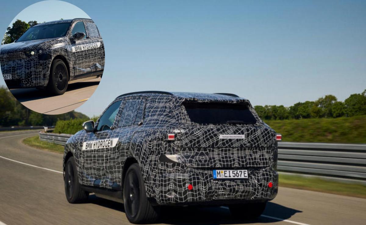 Camouflaged prototype SUV undergoing testing on a road.