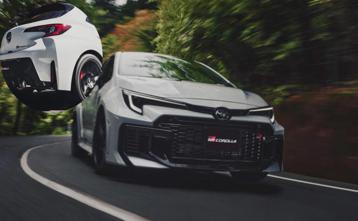 A sleek black sports car driving on a road surrounded by greenery.