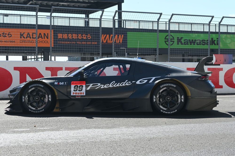 Sleek race car with bold decals parked by the track.