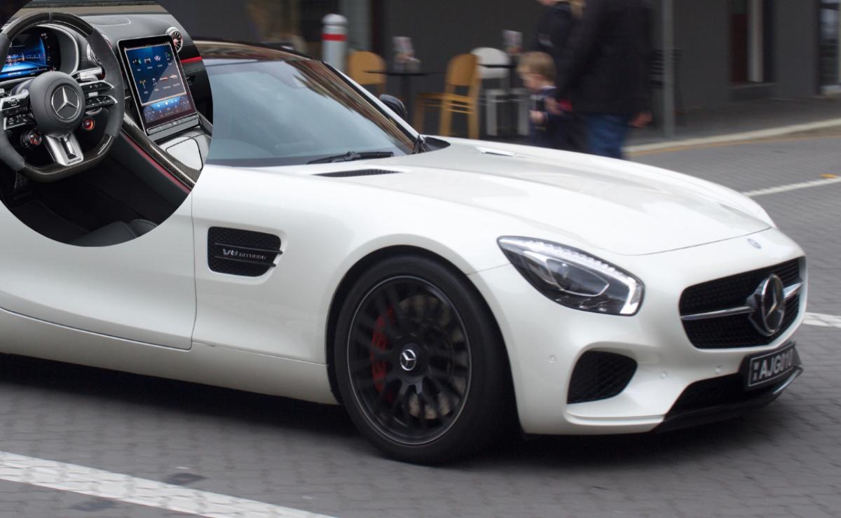 Close-up of a sleek white sports car on a city street.