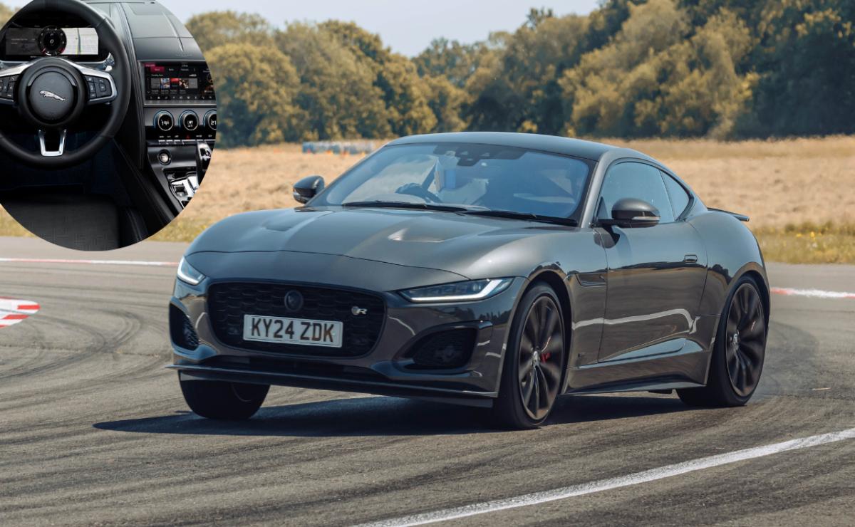 A sleek black Jaguar sports car driving on a road.